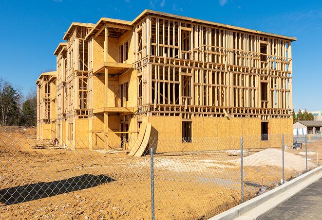 a temporary chain link fence winding around a job site, outlining the project's progress in Glendale Heights, IL